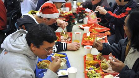 On Christmas day, people eat free hot Christmas dinners at the Glide Memorial Methodist Church in San Francisco, Friday, Dec. 25, 2009. Glide expects to serve 5,000 turkey and ham meals today.