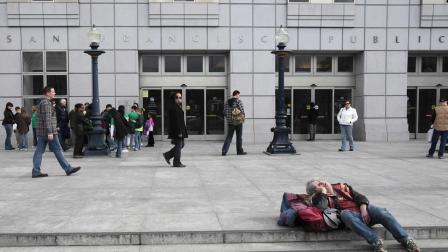 In this photo taken Jan. 29, 2010, people wait for the San Francisco Public Library to open in San Francisco. (AP Photo/Marcio Jose Sanchez)