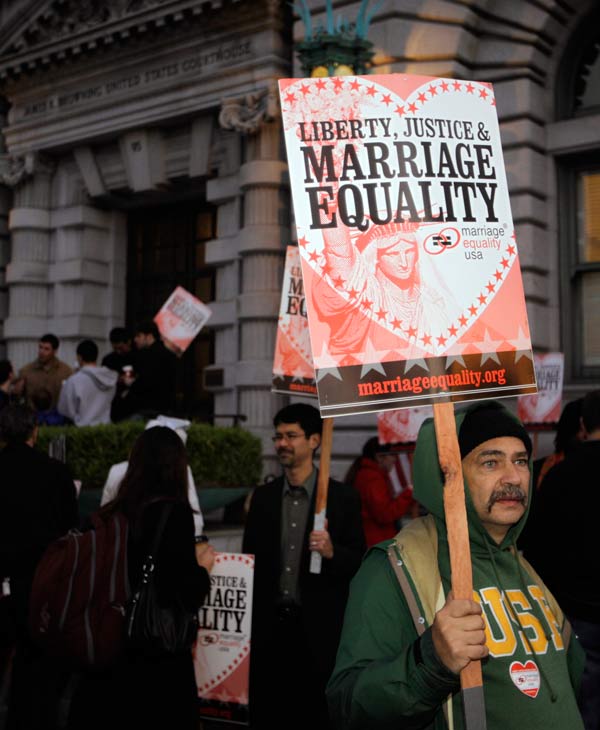 Ernest Camisa, right, of San Francisco, carries...