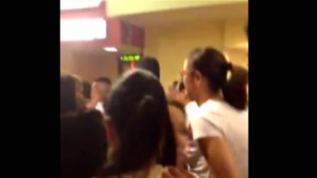 An image from cell phone video shows moviegoers evacuating a theater at Eastridge Mall in San Jose.
