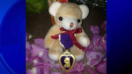 An unidentified soldie left a Purple Heart at the growing memorial to honor two fallen Santa Cruz police officers.