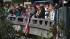People line an overpass to honor fallen Santa...