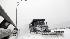 A snow plow works to clear the roadway as snow...