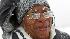 Clara Martin walks through a snow storm that is...
