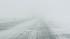 A car on the road during snow storm, near the...