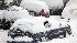 Residents dig their cars out of the snow in...