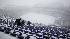 Workers remove snow from the stands at M&T Bank...