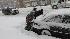A group of men volunteer to push a vehicle out...
