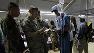 US military doctors discuss the medical history of Betina Joseph, 5, as she lies with her mother Denise Exima, 28.