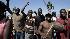 Earthquake survivors chant during a...