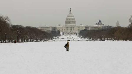 A woman walks through the snow on the National Mall in Washington D.C.