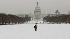 A woman walks through the snow on the National Mall in Washington D.C.