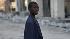 A boy crosses a street in downtown Port-au-Prince, in the aftermath of Haitis earthquake, Tuesday, Feb. 9, 2010. (AP Photo/Rodrigo Abd)