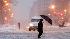 A pedestrian navigates the snow covered streets of downtown Washington.