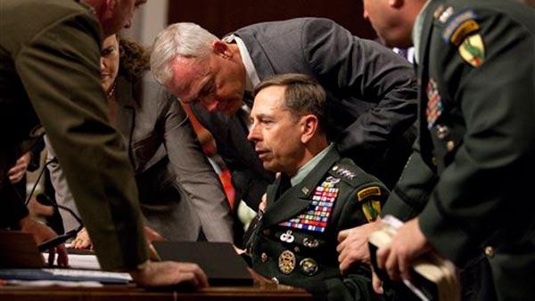 U.S. Central Commander Gen. David Petraeus is surrounded by staff after appearing to pass out on Capitol Hill in Washington.