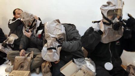 South Korean residents wear their gas masks at a shelter on Yeonpyeong island, South Korea.