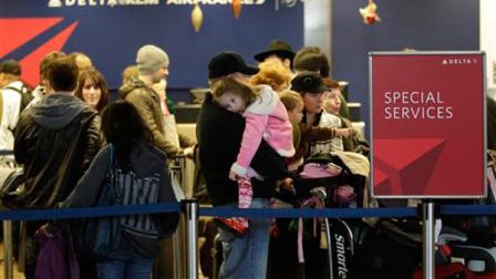 Travelers wait to check-in at a Delta Air Lines counter at Seattle-Tacoma International Airport, Monday, Dec. 27, 2010, in Seattle. Delta and other airlines had flights to and from the New York area cancelled or otherwise affected by winter weather.