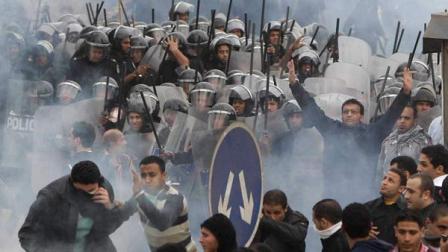 Egyptian anti-government activists clash with riot police in Cairo, Egypt, Friday, Jan. 28, 2011.