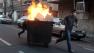 Iranian protestors moving a garbage can which is set on fire, during an anti-government protest in Tehran, Iran.