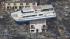 A ferry stranded on a building is seen in...