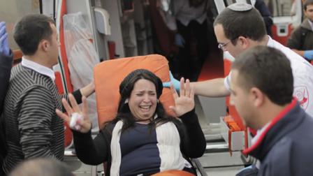 A blast ripped through a bus stop in Jerusalem killing a woman and wounding two dozen others
