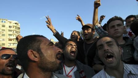 Protesters chant slogans as they march following an attack by security forces in Tahrir Square in Cairo, Egypt