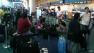 Passengers wait near the United Airlines counter in Portland.