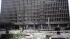 Debris covers the area outside a building in the...