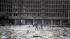 Debris covers the area outside a building in the...