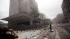 Debris covers the street outside buildings in...