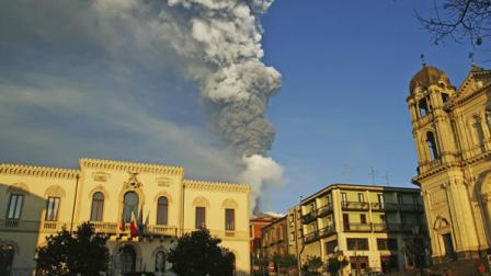 Smoke and ash billow from Mount Etna framed by the Sicilian town of Zafferana, near Catania, southern Italy, Thursday Jan. 5, 2012.