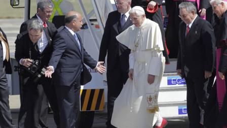 Pope Benedict XVI walks with Cubas President Raul Castro, second right, as he arrives to Antonio Maceo airport in Santiago de Cuba, Cuba, Monday March 26, 2012.