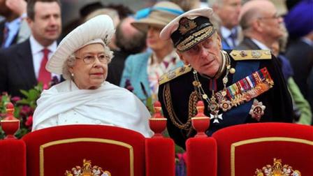 FILE - A Sunday June 3, 2012 photo from files showing Britains Queen Elizabeth II, and her husband Prince Philip watching the proceedings from the royal barge during the Diamond Jubilee Pageant on the River Thames in London.