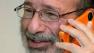 This photo provided by Stanford News Service, shows Alvin Roth taking a phone call, after being awarded the Nobel economics prize, at his home in Menlo Park, Calif. on Monday, Oct. 15, 2012.