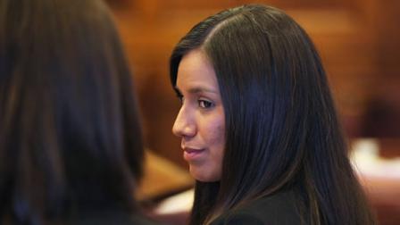 Alexis Wright, 29, turns towards her attorney Sarah Churchill, left, during her arraignment in Portland, Maine on 109 counts of prostitution, violation of privacy, tax evasion and other charges.