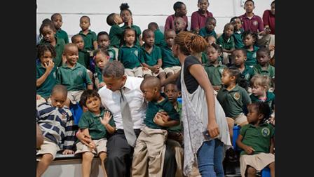 Kid caught sneaking a kiss in Obama photo