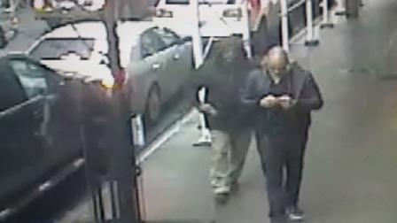 This still image made from a video provided by the New York City Police Department shows the gunman, left, behind Brandon Lincoln Woodard