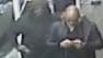 This still image made from a video provided by the New York City Police Department shows the gunman, left, behind Brandon Lincoln Woodard