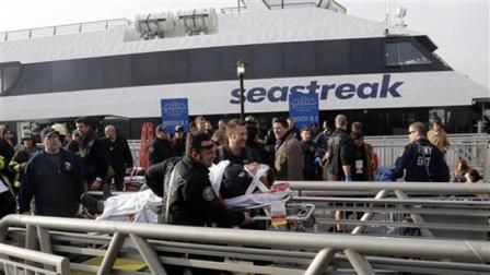 New York City firefighters remove an injured passenger of the Seastreak Wall Street ferry, in New York, Wednesday, Jan. 9, 2013.