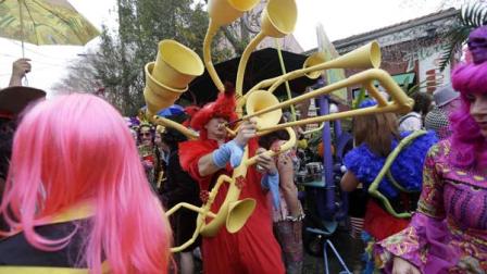 Revelers gather for the start of the Society of Saint Anne walking parade during Mardi Gras