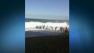 A 12-year-old New Zealand boy is alive after being pulled from the surf by rescuers who formed a human chain to rescue him.