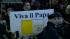 Guys holding up signs and smiling after new pope...