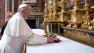 In this photo provided by the Vatican newspaper LOsservatore Romano, Pope Francis puts flowers on the altar inside St. Mary Major Basilica, in Rome, Thursday, March 14, 2013.