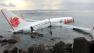 In this photo released by Indonesian Police, the wreckage of a crashed Lion Air plane sits on the water near the airport in Bali, Indonesia
