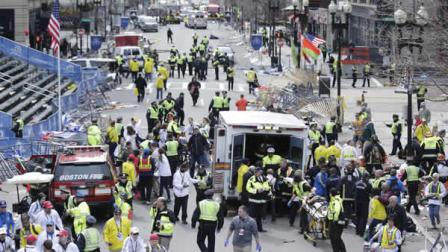 Medical workers aid injured people at the finish line of the 2013 Boston Marathon following an explosion in Boston, Monday, April 15, 2013.