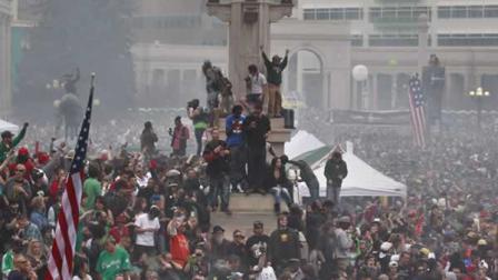 Members of a crowd numbering tens of thousands smoke marijuana and listen to live music, at the Denver 420 pro-marijuana rally at Civic Center Park in Denver on Saturday, April 20, 2013.