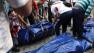 People prepare to carry bodies of victims after several explosions killed at least 40 people and injured dozens in Reyhanli, near Turkeys border with Syria, Saturday, May 11, 2013