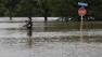 A man photographs flood waters caused by heavy rains, Saturday, May 25, 2013, in San Antonio. (AP Photo/Eric Gay)