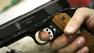 A model 1911 pistol is held in the hands of an assembler prior to being test fired at the Smith and Wesson factory in Springfield