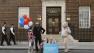A Prince Harry lookalike talks with a royal supporter as he turns up to donate toys as a publicity stunt outside the Lindo Wing at St Marys Hospital in London.